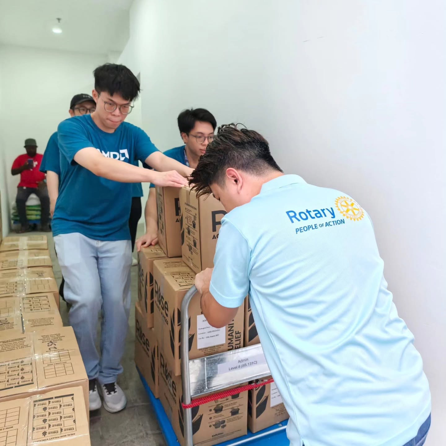 Rotary Club Penang Strait members loading relief supplies